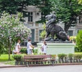 Lion sculpture, people taking photos
