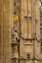 A lion stands guard before the royal entrance below the Victoria tower at the British Parliament building in London, England.