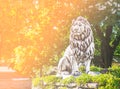 Lion statue standing in forest and nature.