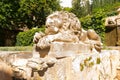 Lion stone sculpture at a traditional Mediterranean garden. Classical Italian style garden at Mallorca. Royalty Free Stock Photo