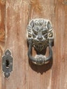 Lionhead doorknob on old wooden door