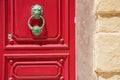 Lionhead doorknob and red door Royalty Free Stock Photo