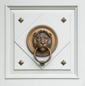 Lionhead knocker found on a door of a classical ma