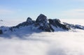 The Lions above the clouds in North Shore Mountains, BC, Canada.