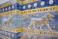 Lions following on the hunt, patterned wall of the historical city of Babylon