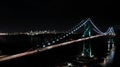 Lions Gate Bridge at night with downtown Vancouver, BC in the background Royalty Free Stock Photo