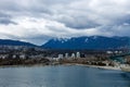 Lions Gate Bridge spans Burrard Inlet with West Vancouver skyline in the background, as storm clouds gather in the sky, creating a Royalty Free Stock Photo