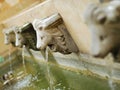 A lions head made of stone to spray water through its mouth through a water pump. Royalty Free Stock Photo