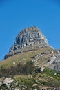 Lions Head mountain with a blue sky and copy space. Beautiful below view of Rocky Mountain peak covered in lots of lush Royalty Free Stock Photo