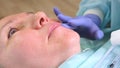 Lip augmentation. Beautician doctor doing a beauty procedure to female lips with a syringe. elderly woman. Lip Royalty Free Stock Photo