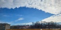 Lip shaped firmament with white fluffy clouds.