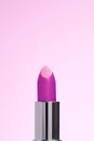 Lipctick bullet macro.  Close up of lipstick in silver packaging on pink background Royalty Free Stock Photo