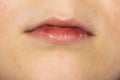 A lips of a boy. A part of face of kid. A Skin background