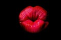 Lips kiss isolated on black. Close up of womans pouting lips with red lipstick. Beautiful red lip. Love and kissing Royalty Free Stock Photo