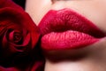 Lips with lipstick closeup. Beauty Red Lips Makeup Detail. Beautiful woman lips with rose. Royalty Free Stock Photo