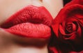 Lips with lipstick closeup. Beauty Red Lips Makeup Detail. Beautiful woman lips with rose. Royalty Free Stock Photo