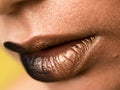 Lips make-up. Beauty high fashion trendy black with gold colour gradient lips makeup sample, mouth closeup.