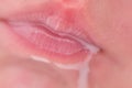 Lips in milk on the face of a newborn baby, close-up. Macro photo of a healthy child mouth after feeding Royalty Free Stock Photo