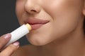 Lips Protection. Close up Beautiful Woman Lips Applying Lip Balm, Lipcare Stick On. Lips Skin Care Cosmetics Concept.