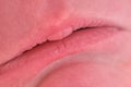 Lips on sad face of a newborn baby, close-up. Macro photo of a healthy child mouth