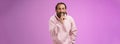 Lips sealed secret. Portrait alluring cheeky stylish adult bearded guy in pink hoodie asking keep quiet show shush shh