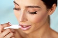 Lips Skin Care. Beautiful Woman Applies Lipbalm Protection On