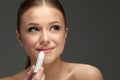 Lips Skin Care. Beautiful Woman Face With Lips Applying Hygienic Lip Balm, Lip Care Stick. Closeup Of Female Face With Soft Skin P Royalty Free Stock Photo