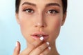 Lips Skin Care. Woman With Beauty Face Applying Lip Balm On Royalty Free Stock Photo