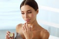 Lips Skin Care. Woman With Beauty Face Applying Lip Balm On Royalty Free Stock Photo