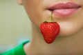 Lips with strawberry.