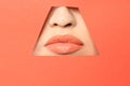 Lips of young woman with beautiful lipstick visible through hole Royalty Free Stock Photo