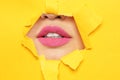 Lips of young woman with beautiful lipstick visible through hole Royalty Free Stock Photo