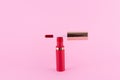 Lipstick and applicator wand on pastel pink background. Liquid lip stick red lip gloss open tube. Makeup cosmetic product. Top Royalty Free Stock Photo