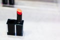 The lipstick in the black suqare shape container