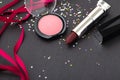 Lipstick and blush on dark stone background Royalty Free Stock Photo