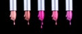 Lipstick colourful tints palette. Fashion Colorful liquid Lipsticks dripping, isolated on black background, Professional Makeup