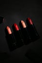 Lipstick. Fashion Colorful Lipsticks over black background. Lipstick tints palette, Professional Makeup and Beauty. Beautiful Make