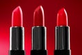 Lipstick. Fashion red Colorful Lipsticks over red background. Red lipstick tints palette, Professional Makeup and beauty Royalty Free Stock Photo