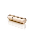 Lipstick in golden tube on white background with mirror reflection on glass surface isolated closeup, shiny gold lipstick package