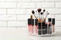 Lipstick holder with different makeup products on table Royalty Free Stock Photo