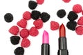 lipstick for lips red and pink colours. candies in the form of raspberries of red and black colour on a white background