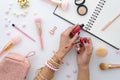 Lipstick makeup swatches on female hand,. Woman holding lipstick. Beauty blog flat lay with makeup accessories Royalty Free Stock Photo