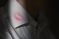 Lipstick marks on the collar of a men`s white shirt