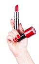 Lipstick and nail polish in a hand Royalty Free Stock Photo