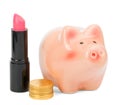 Lipstick with piggy bank and coins