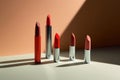 lipstick tubes casting long shadows on a minimal background