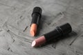 Lipsticks of different shades on grey background Royalty Free Stock Photo