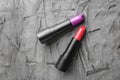 Lipsticks of different shades on grey background Royalty Free Stock Photo