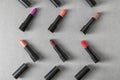 Lipsticks of different shades on grey background Royalty Free Stock Photo