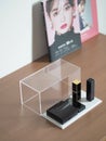 Lipsticks and eyeshadow palettes on the open glass bow with the Japanese fashion magazines
